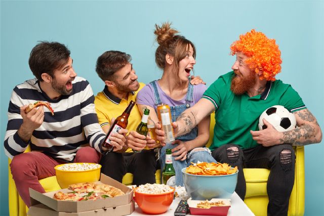 images/three-happy-friends-look-funny-bearded-man-wig-clink-bottles-beer-eat-pizza-have-fun-while-watch-soccer-game-televison.jpg